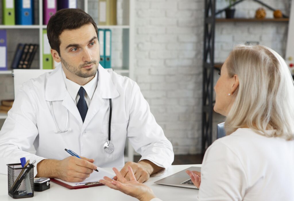 Patient discussing follow-up care and recovery plan with a plastic surgeon after breast reduction surgery