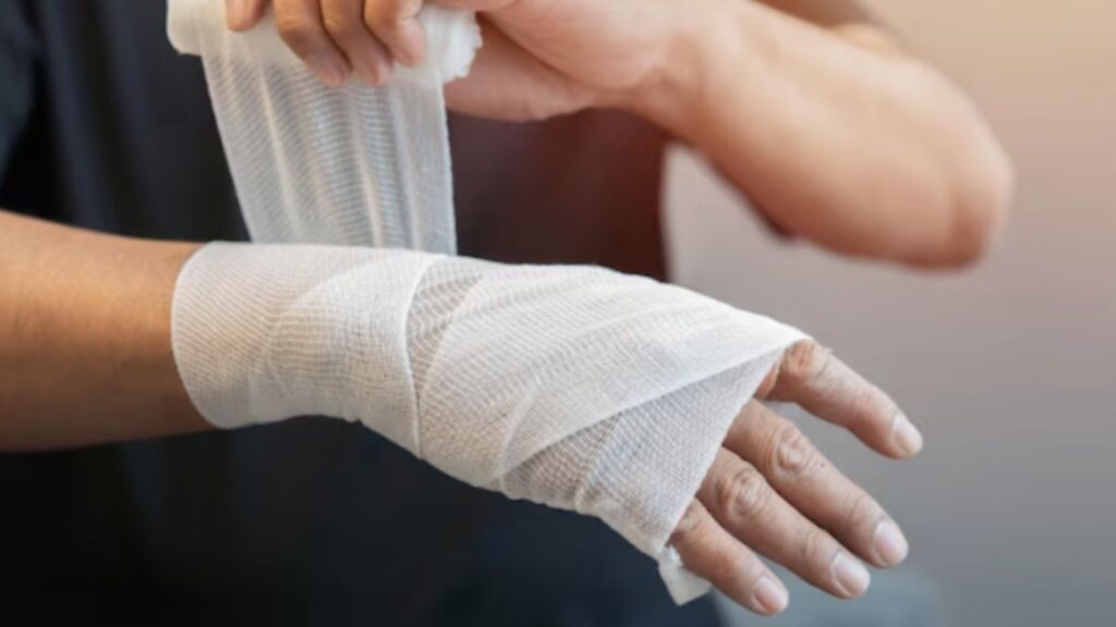 Hand wrapped in medical bandage after reconstructive hand surgery