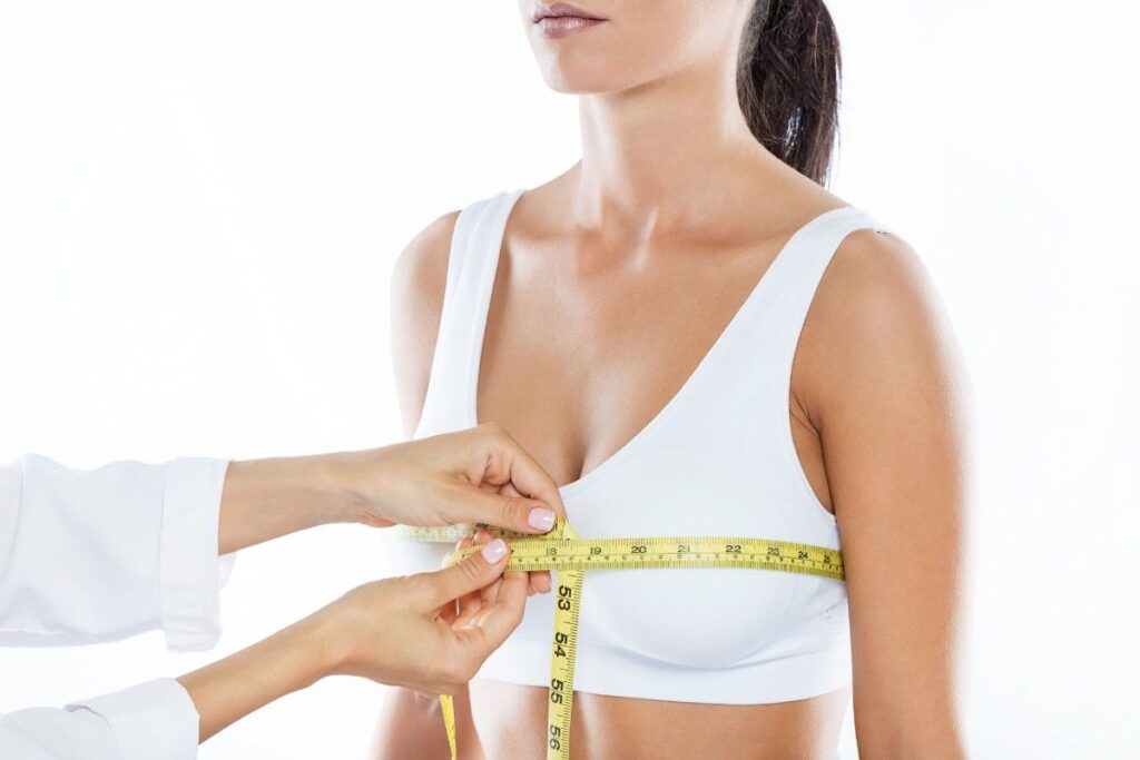 Breast Augmentation Surgery in Thrissur consultation showing breast measurements being taken during preoperative planning for personalized breast enhancement and aesthetic outcomes.